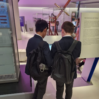Two students in what looks like a museum reading information about an exhibit